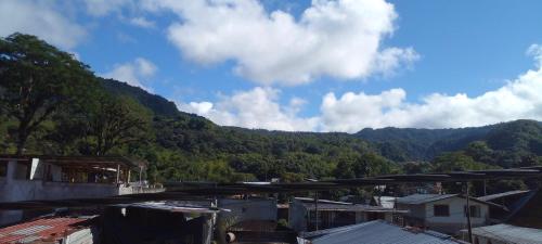 a view of a town with mountains in the background at Aracari Inn Mindo in Mindo