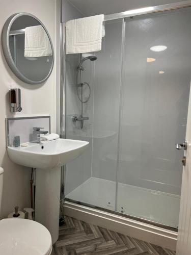 a bathroom with a shower and a sink at 12 Plants Yard -Modern Retreat in Worksop