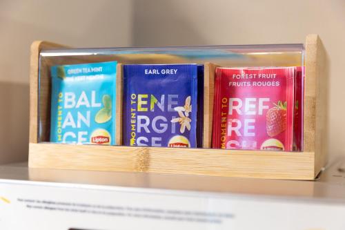 a stack of books sitting on a shelf at Premiere Classe Angers Beaucouzé in Beaucouzé