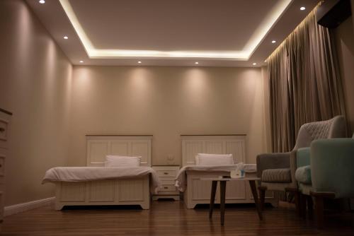 a hospital room with two beds and chairs at Munir’s residence in Cairo