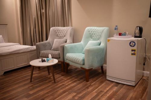 a living room with two chairs and a small table at Munir’s residence in Cairo