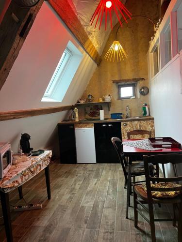 eine Küche mit einem Tisch und einem Esszimmer in der Unterkunft Manoir de La Barre Ceton in Ceton