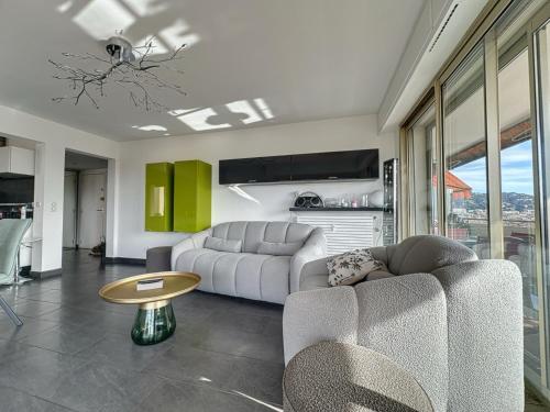 a living room with a couch and a table at AGENCIA appartement 2 chambres au Suquet in Cannes