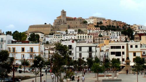 a group of white buildings in front of a city at Single Room in Ibiza Town