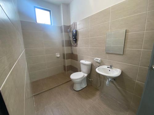 a bathroom with a toilet and a sink at KSP Guest House in Melaka