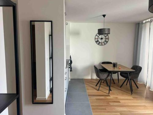 a dining room with a table and a mirror at Charmant Studio in Geneva