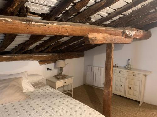 a bedroom with a bed and a wooden ceiling at Patones de Arriba Brother Law SL in Patones