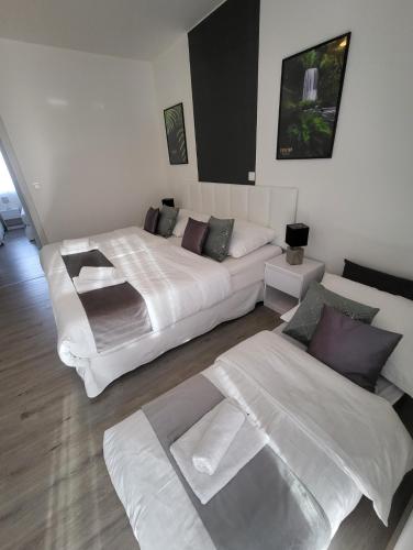 a bedroom with two beds and a couch in it at Apartmán Gabriela in Roudné