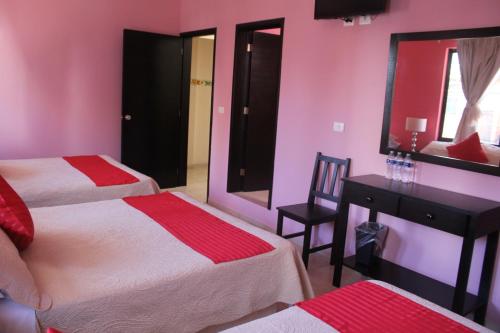 Postel nebo postele na pokoji v ubytování Hotel Boutique La Orquidea