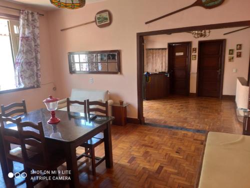 a dining room and living room with a table and chairs at Pousada San Salvador in Salvador