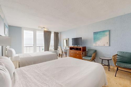 a hotel room with two beds and a flat screen tv at Bayside at Sandestin #6580 in Destin