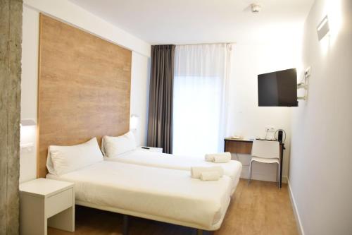 En eller flere senger på et rom på Uma Suites Ondarreta