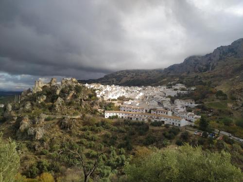 a town on top of a hill with mountains at Amapola Alojamiento Rural in Zuheros