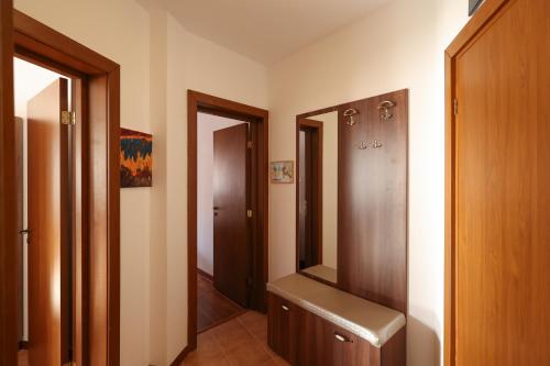 a hallway with a mirror and a dressing room at Pirin Golf Mountain View Retreat in Razlog