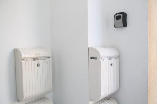 two white radiators sitting next to a wall at My Home in Igualada in Igualada