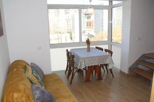 sala de estar con mesa, sillas y sofá en My Home in Igualada, en Igualada