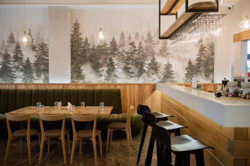 a dining room with a wooden table and chairs at Cabana Bistrita in Durau
