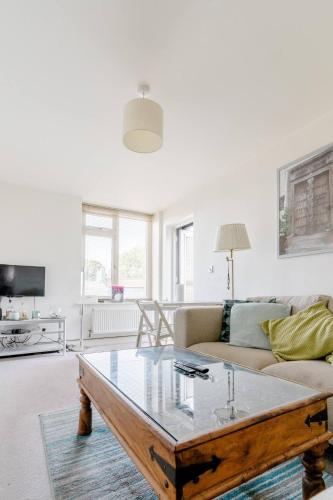 a living room with a couch and a coffee table at Modern apartment with terrace in Bristol