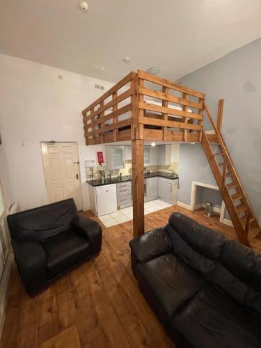 a living room with a loft bed and a couch at Mezz Apartment Four in Hull