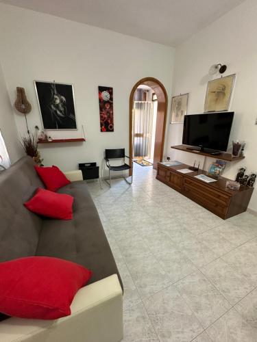 uma sala de estar com um sofá e uma televisão de ecrã plano em Appartamento Annesca - Delta del Po em Porto Tolle