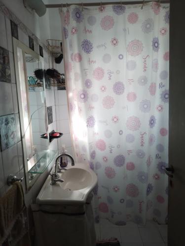 a bathroom with a sink and a shower curtain at Alquiler temporario villa Carlos Paz in Villa Carlos Paz