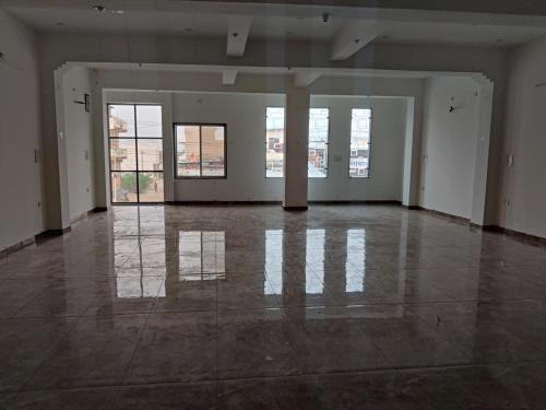 an empty room with white walls and floors and windows at Hotel Neelkanth Prime Retreat, Kekri in Kekri