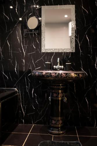 a bathroom with a sink and a mirror at Munir’s residence in Cairo