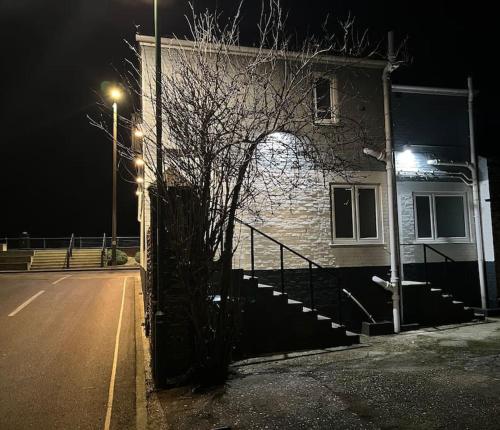 a building on the side of a street at night at Riverside Seaside Apartment in Littlehampton