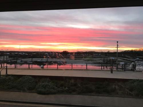 a view of a parking lot with a sunset at Riverside Seaside Apartment in Littlehampton