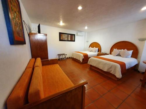 Ліжко або ліжка в номері Hotel Real del Valle Tepoztlán