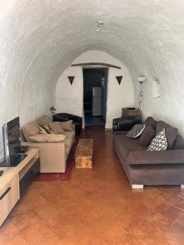 a living room with two couches and a television at Cassano, Maison de village 4/6 personnes à 15mn de Calvi in Cassano