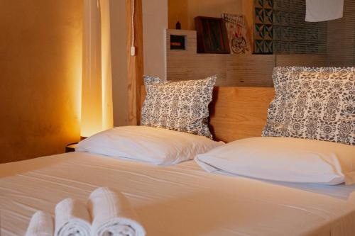 a bed with white sheets and pillows on it at Casa Flora in Vietri sul Mare