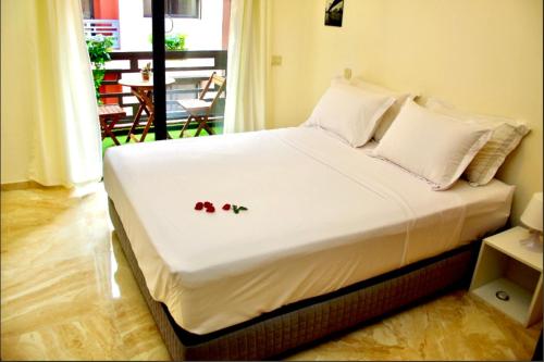 a bed with flowers on it in a room at Luxurious KING Bed SUITE W/POOL. Well centered. in Marrakech