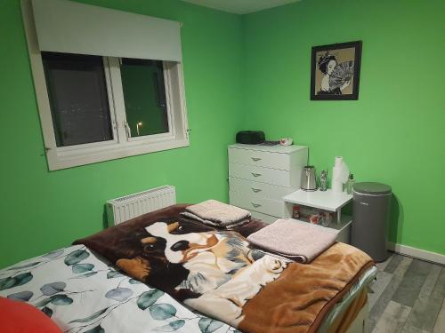 a bedroom with a bed with a cow blanket on it at Bastolino in Newtongrange