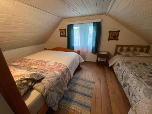 Habitación pequeña con 2 camas en un ático en Hospedaje Nehuen Karu, en Puerto Varas