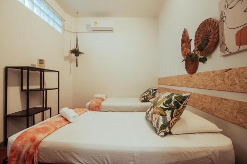 a bedroom with two beds and a window at Centro Hostel Medellin in Medellín