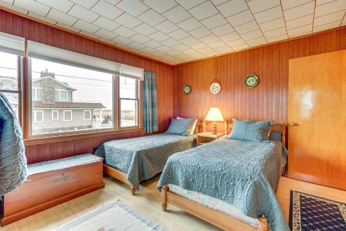 a bedroom with two beds and a window at Beachfront Lavallette Home - 2 Mi to Casino Pier! in Lavallette
