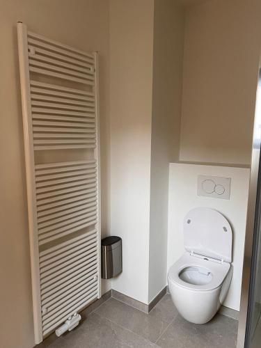 a bathroom with a white toilet in a room at DuplexJacob2 in Antwerp