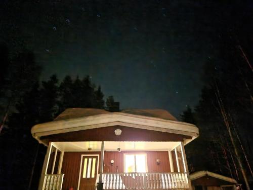 a small house with a porch at night at Överkalix Kalixalven Lodge Jockfall in Jock