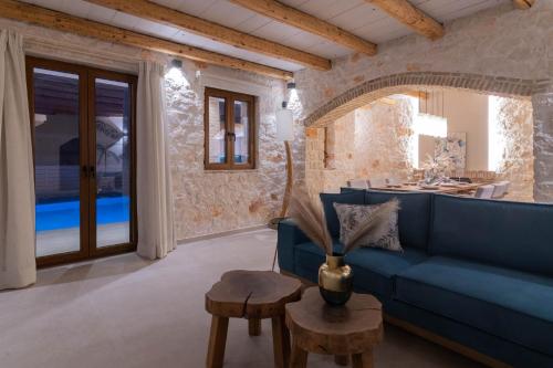 a living room with a blue couch and a table at Porta del mar Beach Resort in Meson Yerakarion