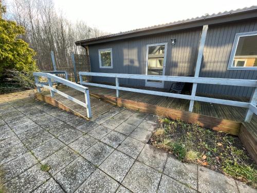 a house with a porch and a fence at KragenæsHus in Torrig