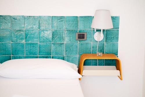 a bedroom with a bed and a table and a lamp at Casa Flora in Vietri sul Mare