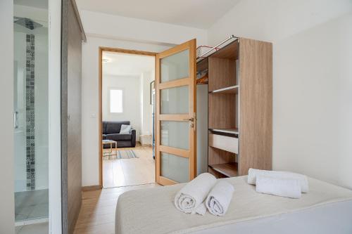 een slaapkamer met een bed met handdoeken erop bij T1 BIS Centre Ville - Vue mer ! in Saint-Pierre