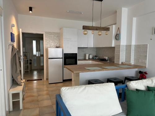 a kitchen with a white refrigerator and a counter at Krasas Beach in Larnaka