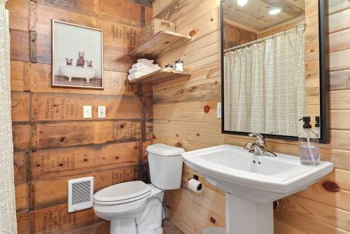 a bathroom with a white toilet and a sink at Sun Filled Joy BHBungalows #8 in Custer