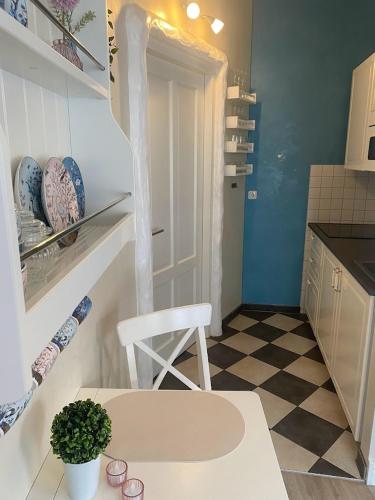 a kitchen with a white table and a white chair at Nordseeperle in Norden