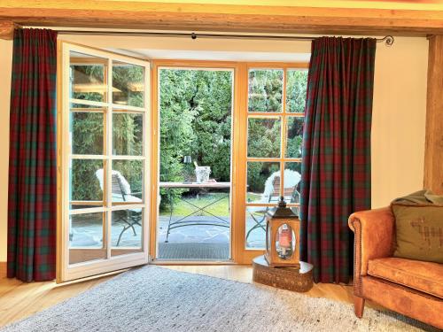 a living room with a sliding glass door at Mountain Suites by Belle-Stay in Kitzbühel