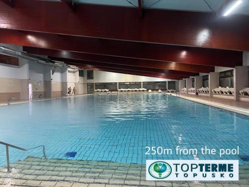 a large swimming pool in a building at Top Art Topusko Apartments in Topusko