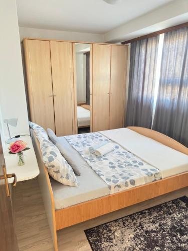 a small bedroom with a bed and a desk at Apartment Maky in Zadar