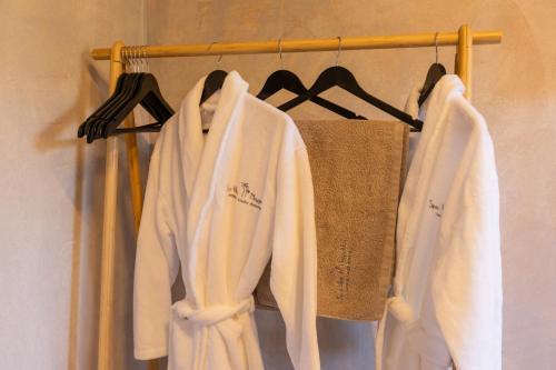 a group of white towels hanging on a rack at Spa Villas Nafpaktos in Nafpaktos